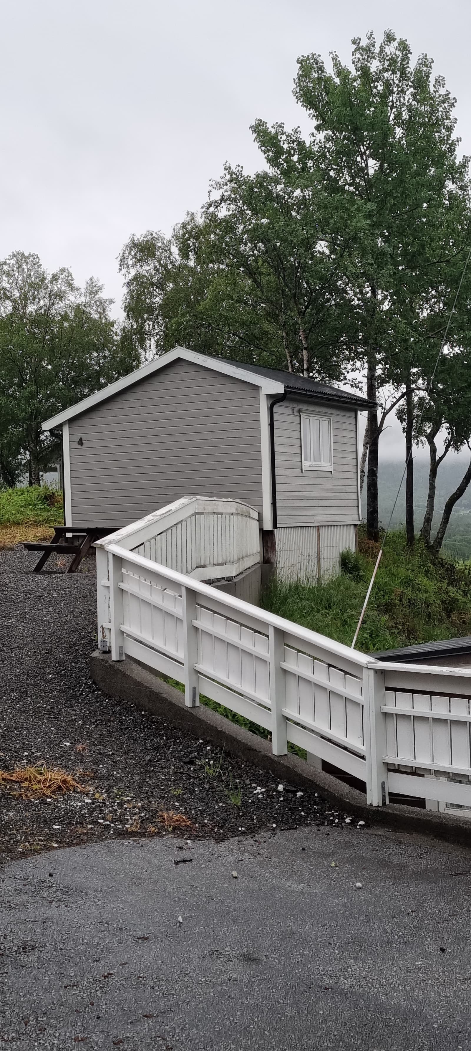 Cabin 4 from outside, with a railed deck and a table